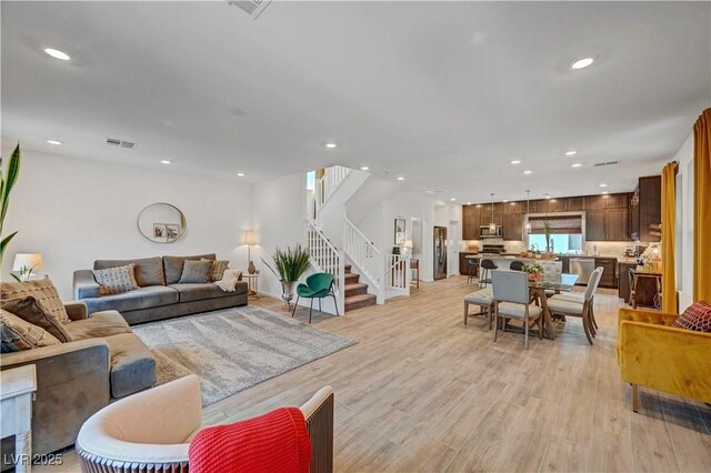 7756 Seville Estates Ct, Las Vegas, NV 89113 - living room with stairs, recessed lighting, and light wood-type flooring