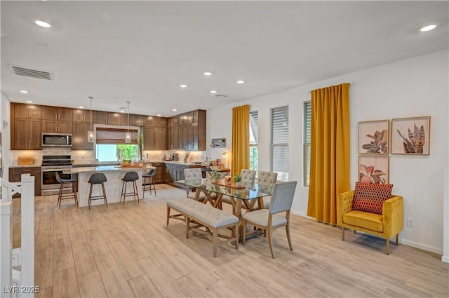 7756 Seville Estates Ct, Las Vegas, NV 89113 - dining area featuring light wood-style floors and recessed lighting