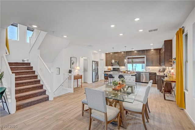 7756 Seville Estates Ct, Las Vegas, NV 89113 - dining space featuring light wood finished floors, stairs, and recessed lighting