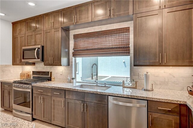 7756 Seville Estates Ct, Las Vegas, NV 89113 - kitchen featuring stainless steel appliances, a sink, decorative backsplash, and recessed lighting