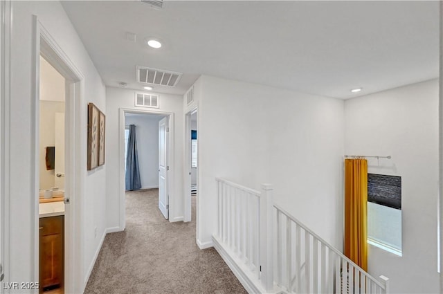 7756 Seville Estates Ct, Las Vegas, NV 89113 - corridor featuring an upstairs landing, light carpet, baseboards, and recessed lighting