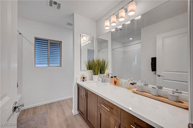 7756 Seville Estates Ct, Las Vegas, NV 89113 - bathroom with wood finished floors, vanity, and baseboards
