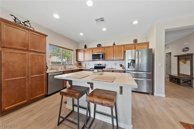 5375 E Ln Campana Dr, Pahrump, NV 89061 - kitchen featuring appliances with stainless steel finishes, decorative backsplash, a center island, light wood-style flooring, and recessed lighting