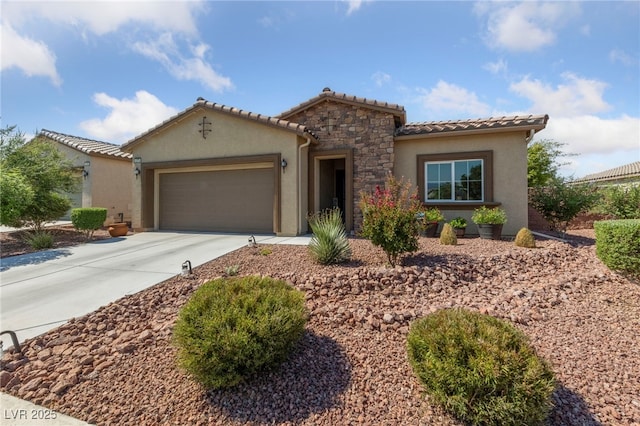 5375 E Ln Campana Dr, Pahrump, NV 89061 - mediterranean / spanish-style house featuring stucco siding, driveway, an attached garage, stone siding, and a tile roof