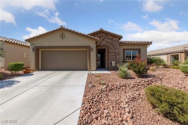 5375 E Ln Campana Dr, Pahrump, NV 89061 - mediterranean / spanish-style home featuring driveway, a garage, stucco siding, a tiled roof, and stone siding