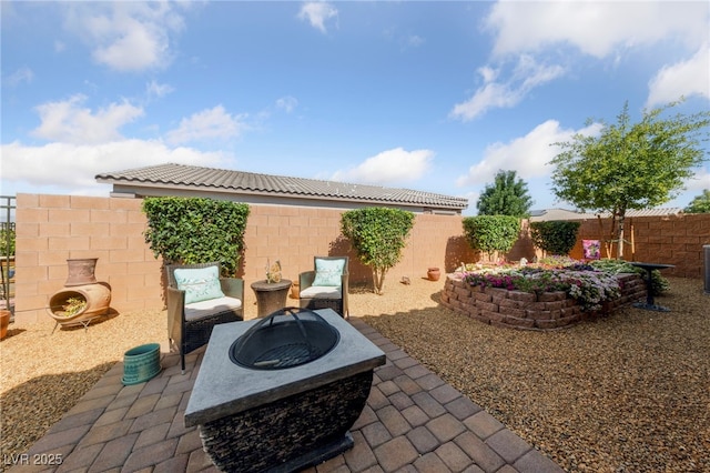 5375 E Ln Campana Dr, Pahrump, NV 89061 - fenced backyard featuring a patio and an outdoor fire pit