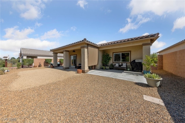 5375 E Ln Campana Dr, Pahrump, NV 89061 - rear view of property featuring stucco siding, a tile roof, and a patio area