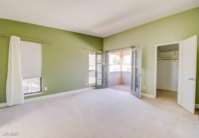 2212 Sunfish Dr Unit C, Henderson, NV 89014 - unfurnished bedroom featuring carpet floors, a walk in closet, baseboards, and french doors