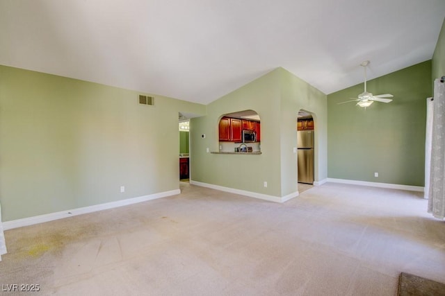 2212 Sunfish Dr Unit C, Henderson, NV 89014 - spare room with lofted ceiling, light carpet, ceiling fan, baseboards, and arched walkways