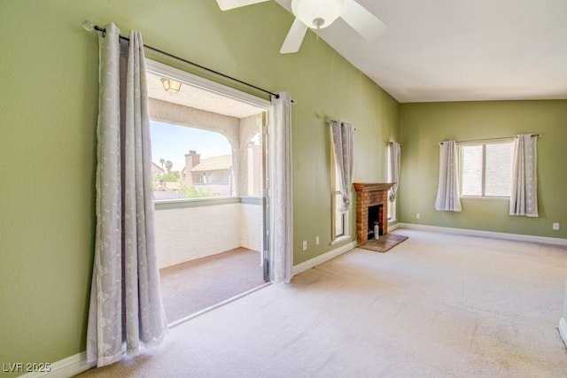 2212 Sunfish Dr Unit C, Henderson, NV 89014 - unfurnished living room featuring carpet flooring, a ceiling fan, a brick fireplace, and baseboards