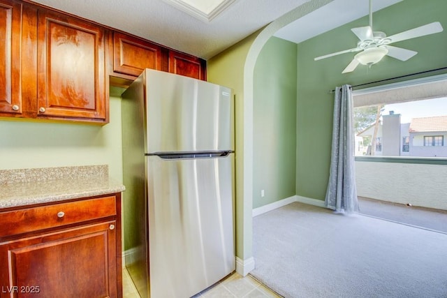 2212 Sunfish Dr Unit C, Henderson, NV 89014 - kitchen featuring freestanding refrigerator, arched walkways, light colored carpet, light countertops, and a ceiling fan
