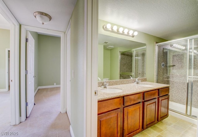2212 Sunfish Dr Unit C, Henderson, NV 89014 - full bathroom featuring a shower stall, a textured ceiling, and double vanity