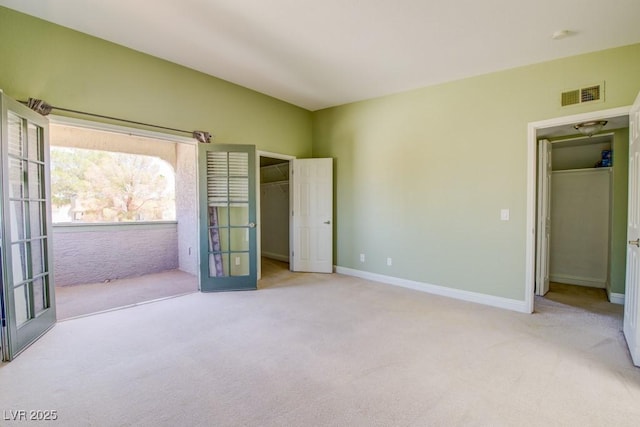 2212 Sunfish Dr Unit C, Henderson, NV 89014 - unfurnished bedroom featuring carpet, a walk in closet, a closet, lofted ceiling, and baseboards