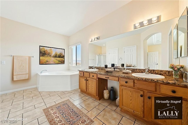 2020 S Omaha Ave, Pahrump, NV 89048 - bathroom featuring double vanity, a garden tub, a shower stall, tile patterned floors, and baseboards