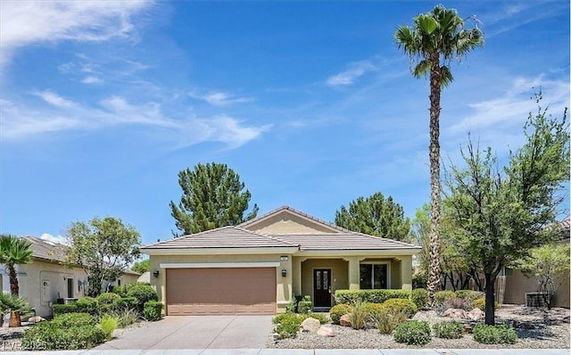 1941 Williamsport St, Henderson, NV 89052 - ranch-style house with an attached garage, driveway, a tile roof, and stucco siding