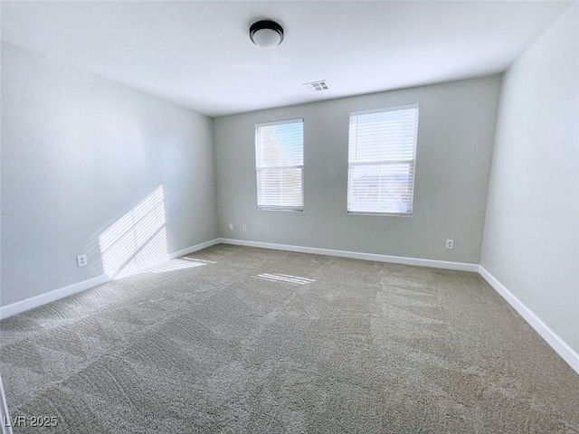unfurnished room with carpet flooring and baseboards