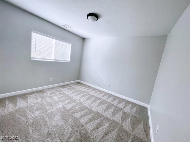 carpeted empty room with baseboards