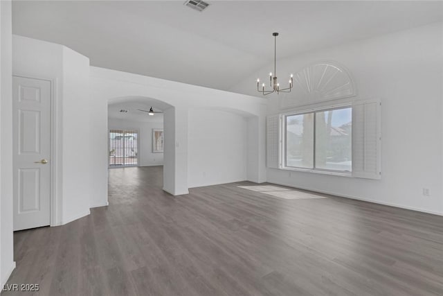 5808 Spinnaker Reach Ave, Las Vegas, NV 89130 - spare room with arched walkways, wood finished floors, a chandelier, vaulted ceiling, and baseboards