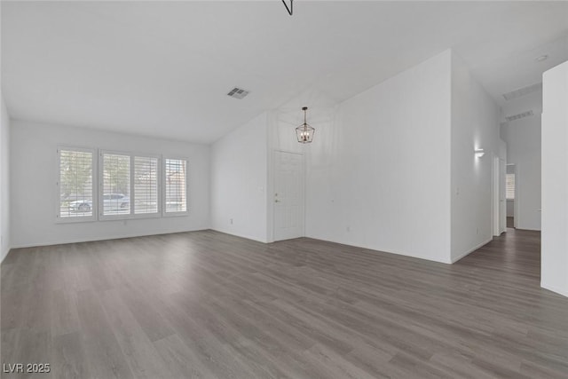 5808 Spinnaker Reach Ave, Las Vegas, NV 89130 - unfurnished living room featuring lofted ceiling, wood finished floors, and a chandelier