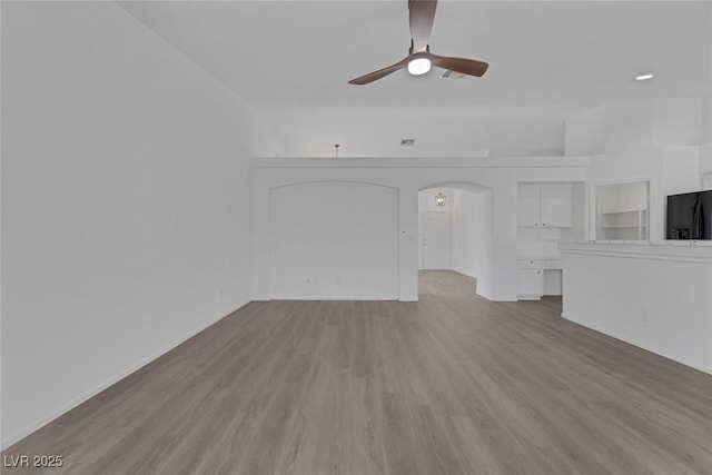 5808 Spinnaker Reach Ave, Las Vegas, NV 89130 - unfurnished living room with ceiling fan, wood finished floors, and arched walkways