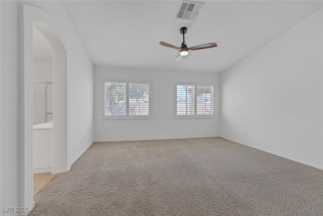 5808 Spinnaker Reach Ave, Las Vegas, NV 89130 - carpeted empty room featuring arched walkways, a ceiling fan, and baseboards