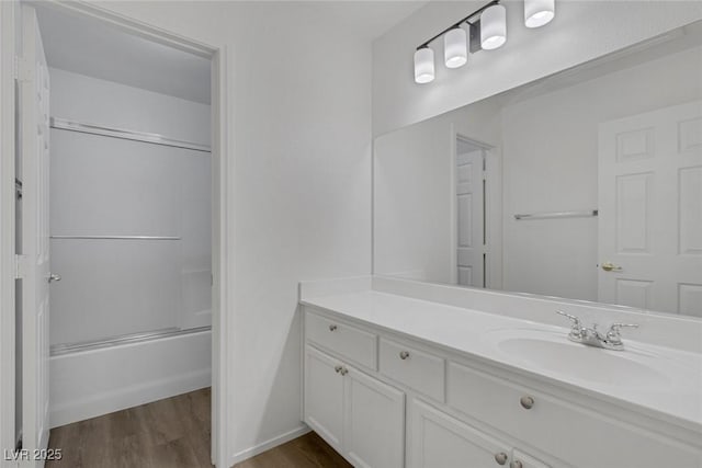 5808 Spinnaker Reach Ave, Las Vegas, NV 89130 - bathroom featuring vanity, wood finished floors, and shower / bath combination with glass door
