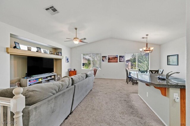 9105 White Eyes Ave, Las Vegas, NV 89143 - living room featuring lofted ceiling, a chandelier, light colored carpet, and ceiling fan