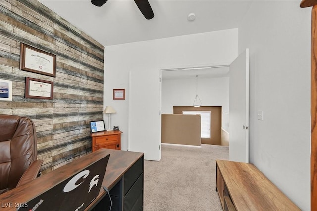 9105 White Eyes Ave, Las Vegas, NV 89143 - home office with wooden walls, ceiling fan, light carpet, and an accent wall