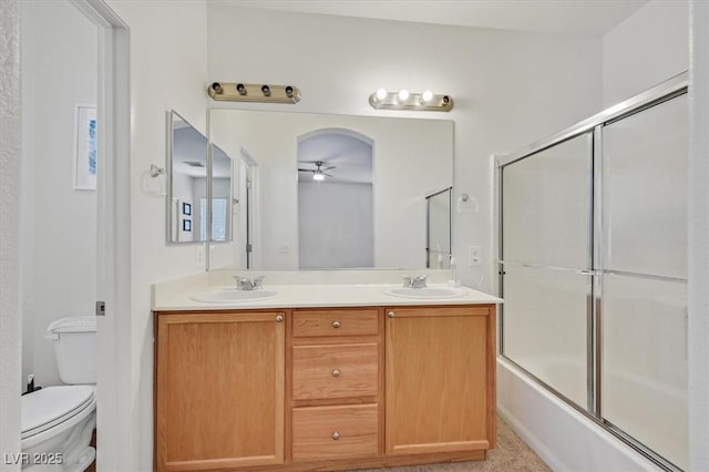 9105 White Eyes Ave, Las Vegas, NV 89143 - bathroom featuring a ceiling fan, double vanity, and enclosed tub / shower combo