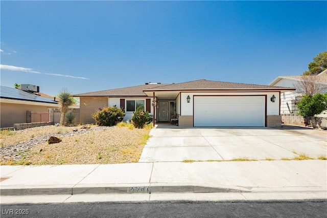 7701 Pheasant Ln, Las Vegas, NV 89145 - ranch-style home featuring an attached garage, concrete driveway, and brick siding
