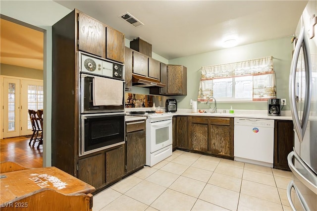 7701 Pheasant Ln, Las Vegas, NV 89145 - kitchen featuring white appliances, a sink, under cabinet range hood, and plenty of natural light
