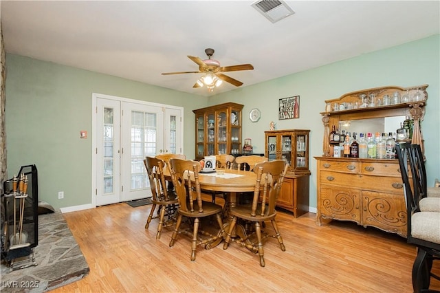 7701 Pheasant Ln, Las Vegas, NV 89145 - dining room featuring light wood-style floors, french doors, ceiling fan, and baseboards