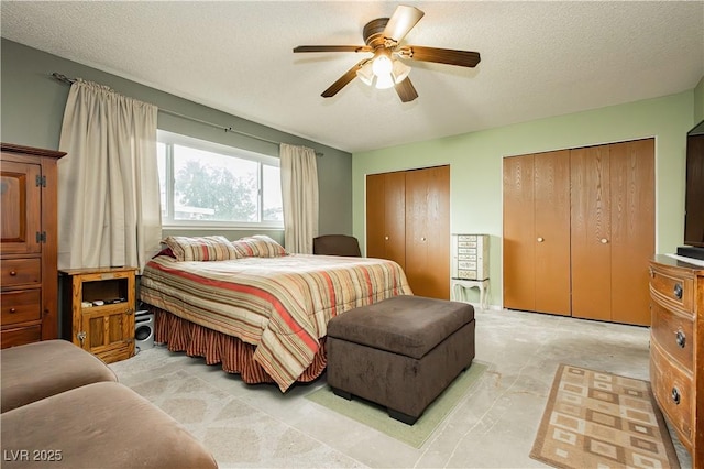 7701 Pheasant Ln, Las Vegas, NV 89145 - bedroom with two closets, a textured ceiling, and a ceiling fan