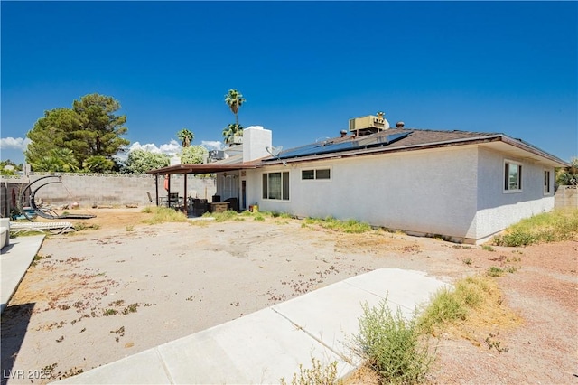 7701 Pheasant Ln, Las Vegas, NV 89145 - rear view of property featuring roof mounted solar panels, a patio, central AC, and stucco siding