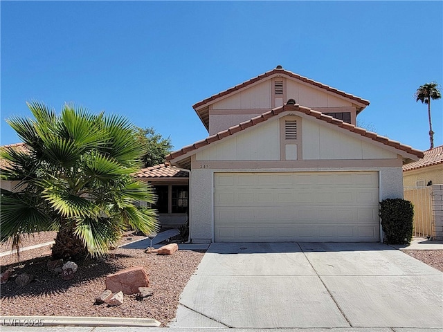 2451 Muirfield Ave, Henderson, NV 89074 - mediterranean / spanish house featuring a tile roof, concrete driveway, and a garage