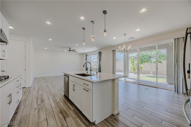 6403 Ava Ridge Ave, Las Vegas, NV 89141 - kitchen featuring a sink, light wood-style flooring, healthy amount of natural light, light countertops, and recessed lighting