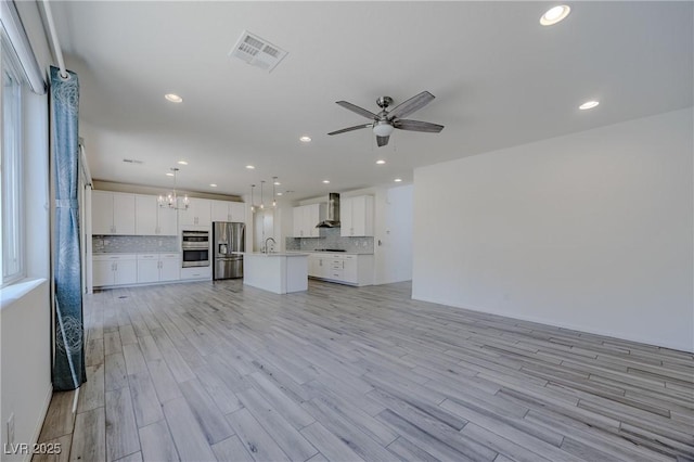6403 Ava Ridge Ave, Las Vegas, NV 89141 - unfurnished living room with a chandelier, ceiling fan, light wood finished floors, recessed lighting, and a sink