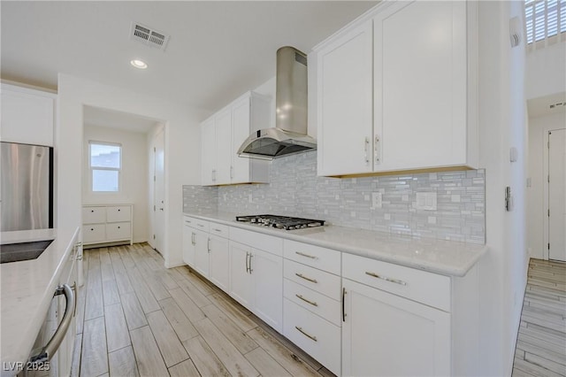 6403 Ava Ridge Ave, Las Vegas, NV 89141 - kitchen featuring wall chimney exhaust hood, stainless steel gas cooktop, healthy amount of natural light, decorative backsplash, and recessed lighting