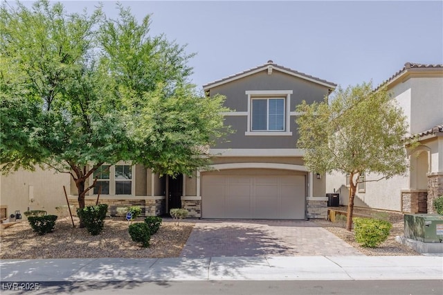 6403 Ava Ridge Ave, Las Vegas, NV 89141 - view of property hidden behind natural elements featuring stone siding, stucco siding, an attached garage, decorative driveway, and central air condition unit