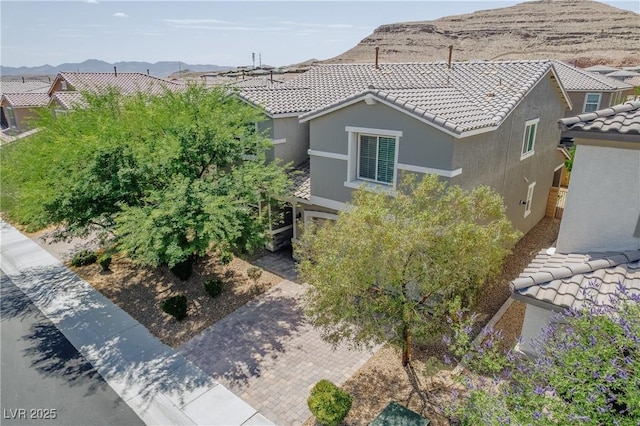 6403 Ava Ridge Ave, Las Vegas, NV 89141 - view of side of property with a tiled roof, stucco siding, and a mountain view