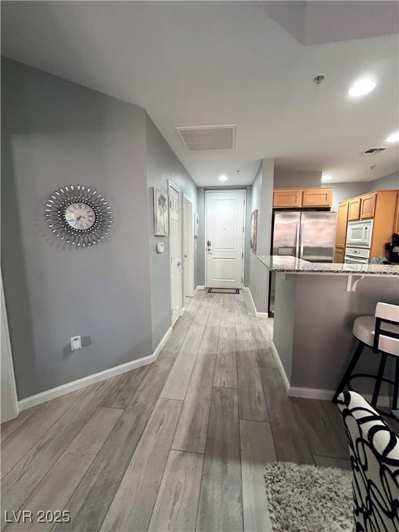 23 E Agate Ave Unit 301, Las Vegas, NV 89123 - hallway with light wood-style floors, baseboards, attic access, and recessed lighting