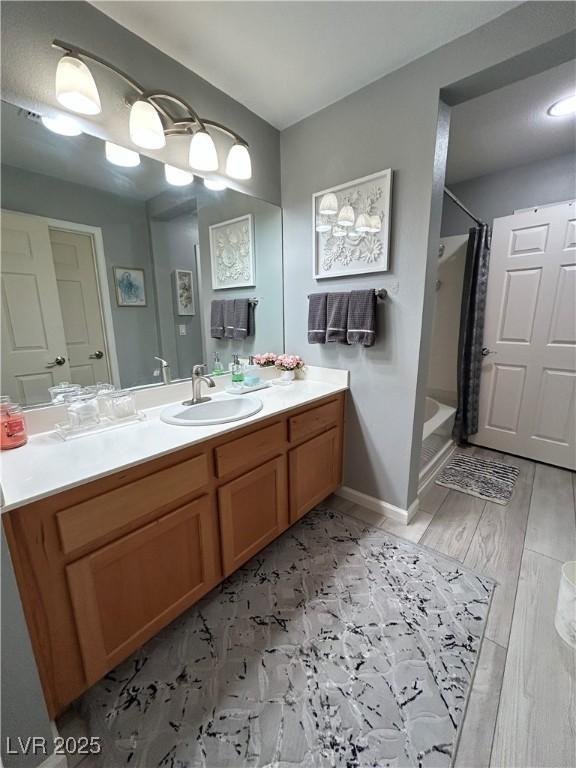 23 E Agate Ave Unit 301, Las Vegas, NV 89123 - bathroom with vanity, a shower with shower curtain, and baseboards