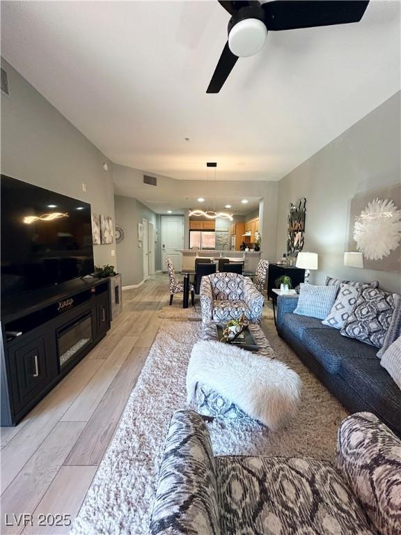 23 E Agate Ave Unit 301, Las Vegas, NV 89123 - living area with ceiling fan and light wood-style floors