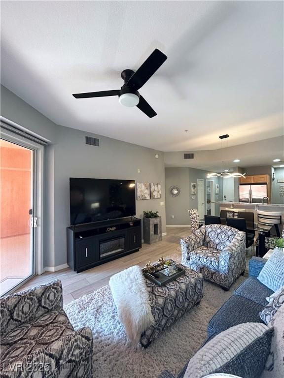 23 E Agate Ave Unit 301, Las Vegas, NV 89123 - living area featuring ceiling fan and baseboards
