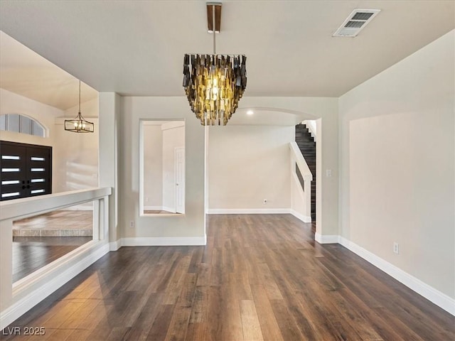 6639 Tranquil Seas Ct, Las Vegas, NV 89139 - unfurnished dining area with a chandelier, wood finished floors, baseboards, stairway, and arched walkways