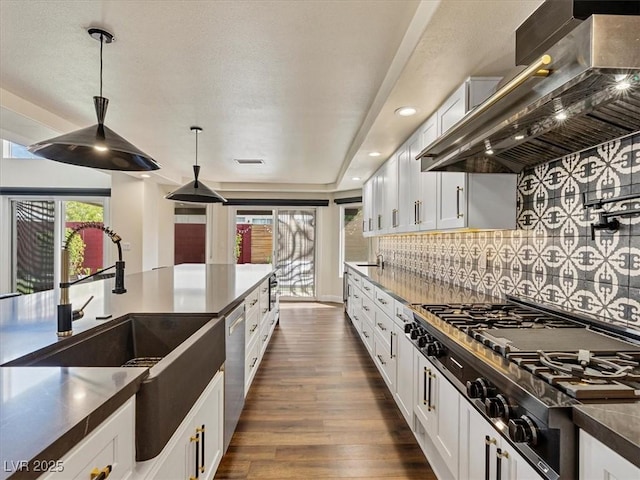 6639 Tranquil Seas Ct, Las Vegas, NV 89139 - kitchen featuring wall chimney range hood, gas cooktop, white cabinetry, decorative backsplash, and dark wood-style flooring