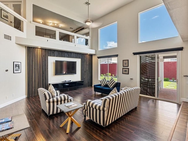 6639 Tranquil Seas Ct, Las Vegas, NV 89139 - living room featuring a high ceiling, wood-type flooring, healthy amount of natural light, and baseboards