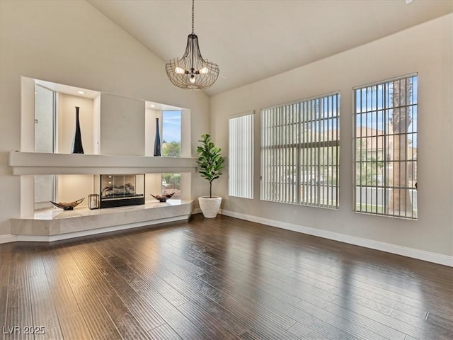 6639 Tranquil Seas Ct, Las Vegas, NV 89139 - living room with healthy amount of natural light, a chandelier, baseboards, and high vaulted ceiling