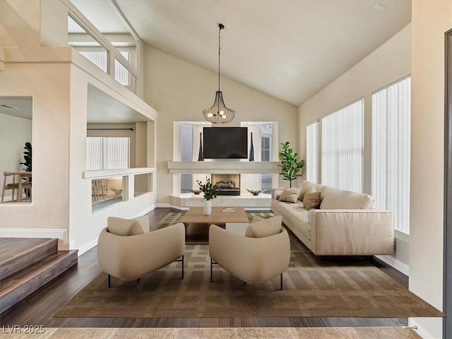 6639 Tranquil Seas Ct, Las Vegas, NV 89139 - living area with healthy amount of natural light, wood finished floors, baseboards, and high vaulted ceiling