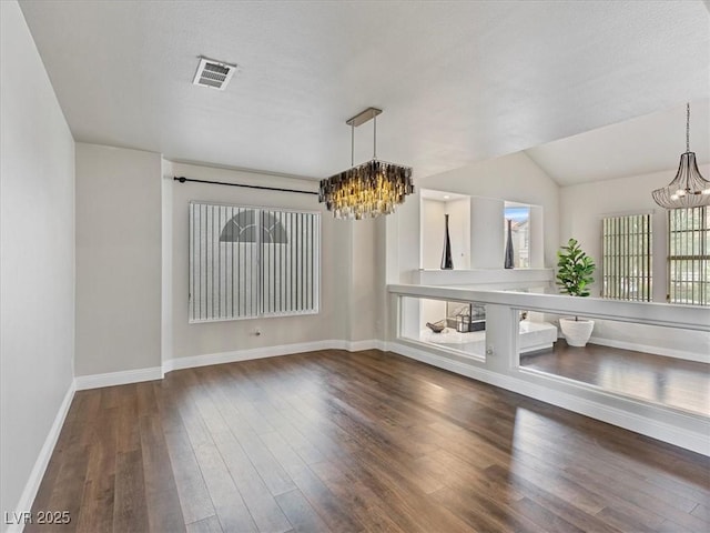 6639 Tranquil Seas Ct, Las Vegas, NV 89139 - unfurnished dining area featuring a chandelier, baseboards, and wood finished floors